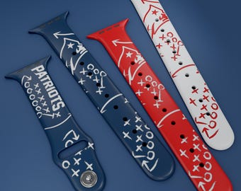 May include: Three silicone watch straps featuring American football play diagrams. One strap is dark blue with the word PATRIOTS and white play graphics. Another is red with white play graphics. The third is white with red play graphics.