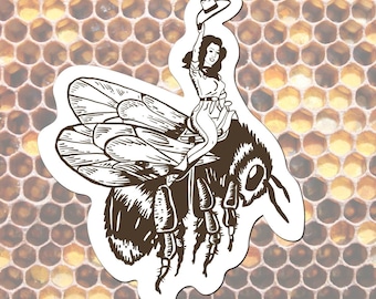 May include: A brown and white sticker featuring a woman riding a large bee, holding a cowboy hat. The bee has detailed wings and legs. The background is a honeycomb pattern.