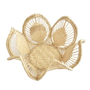 May include: A woven basket shaped like a flower with a light brown color. The basket is made of natural materials and has a unique design.