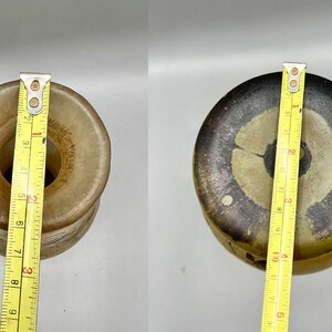 May include: Two ceramic vases with a brown and white glaze. The vase on the left is 7 inches tall and the vase on the right is 9 inches tall.