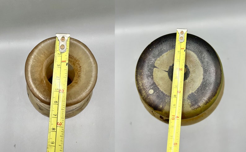 May include: Two ceramic vases with a brown and white glaze. The vase on the left is 7 inches tall and the vase on the right is 9 inches tall.