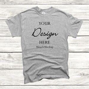 May include: A gray t-shirt with the text "YOUR Design HERE MiracleMockup" printed on the front.