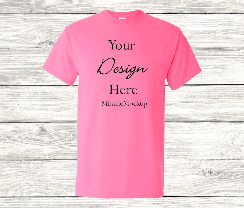 May include: A pink t-shirt with the text "Your Design Here" and "MiracleMockup" printed on the front.