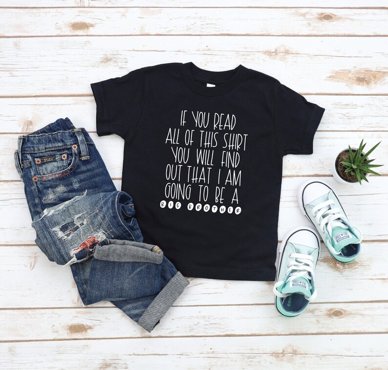 May include: Black t-shirt with white text that reads "If you read all of this shirt you will find out that I am going to be a big brother".
