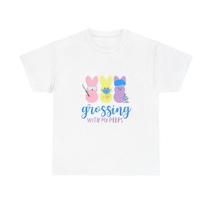 May include: White t-shirt featuring three cartoon Peeps, each with a different medical-themed accessory. The text "grossing with my peeps" is written in blue script. The design is centered on the front of the shirt.