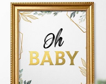 May include: Gold framed printable sign with a white background and gold geometric shapes. The sign has green foliage and the text "Oh Baby" in gold letters.