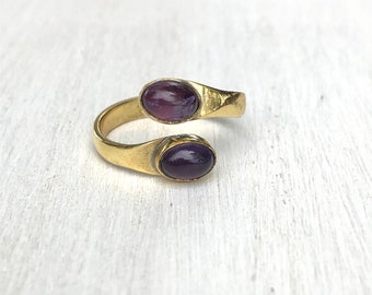 Golden brass ring with fine and delicate design with two amethyst stone. Adjustable