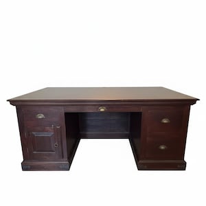 May include: A dark brown wooden desk featuring a rectangular top, a central drawer, and two pedestals. The left pedestal includes one drawer and a cabinet door, while the right pedestal has two drawers. All drawers feature brass shell-shaped pulls.