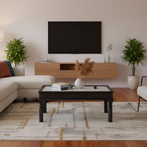 May include: A modern living room with a white sectional sofa, a wooden coffee table, and a large flat-screen TV. The coffee table has a marble top and black legs. Decorative plants and a patterned rug complete the space.