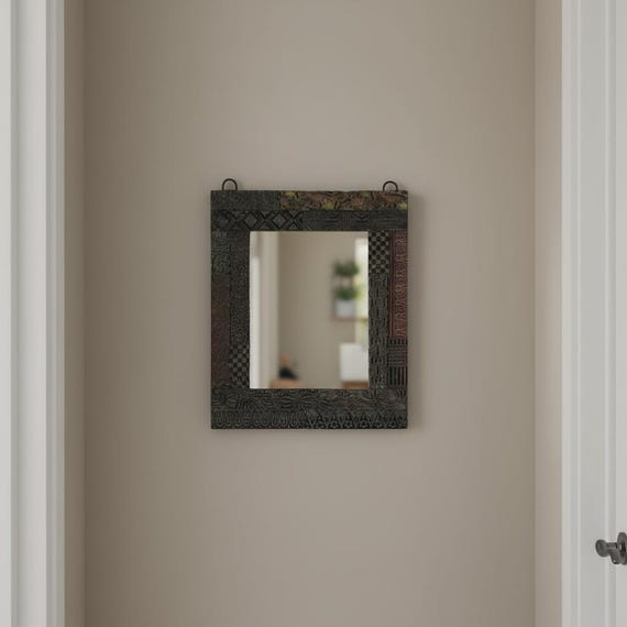 A functional mirror framed with genuine vintage wood printing blocks — actual pieces of typographic history repurposed into wall art you won't find anywhere else.