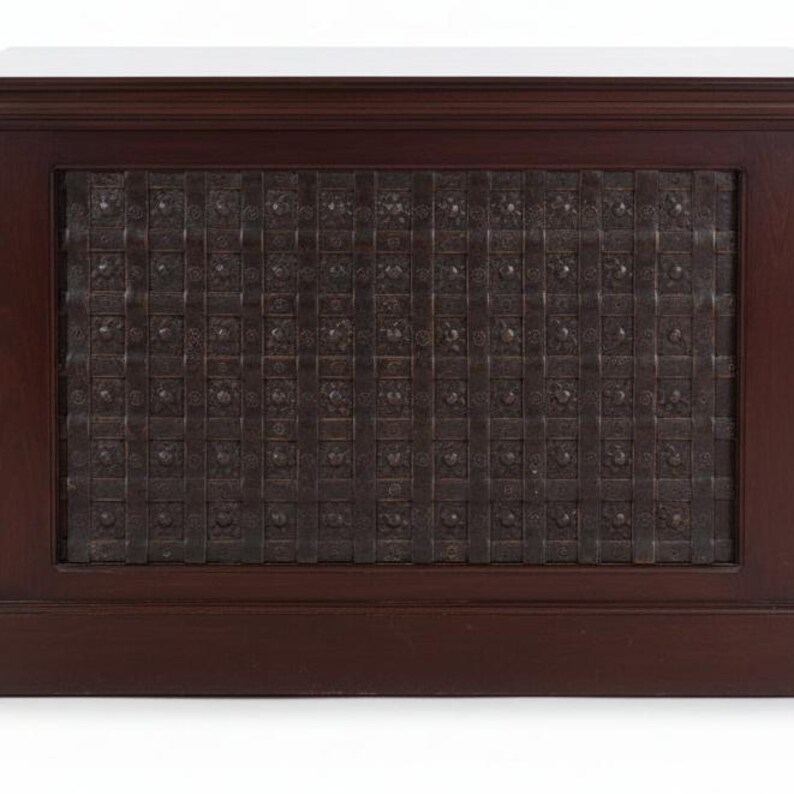 May include: A rectangular wooden cabinet featuring a dark brown finish and a central panel composed of a dark metal grid. The grid consists of intersecting vertical and horizontal metal strips, each adorned with small, evenly spaced metal studs.