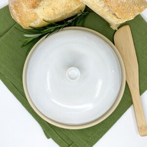 White medium-sized ceramic butter keeper with lid in modern style.