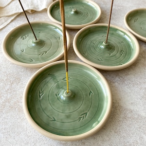 Handmade green round pottery incense holders for yoga lovers.
