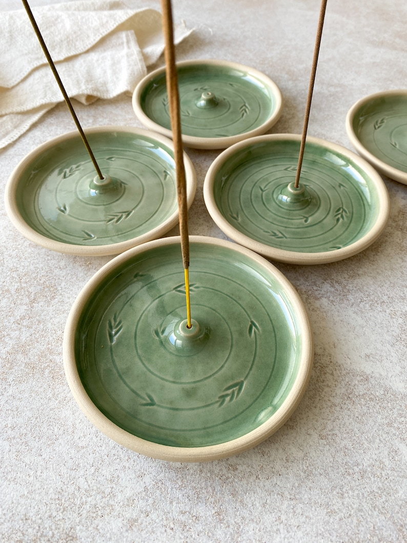 Handmade green round pottery incense holders for yoga lovers.