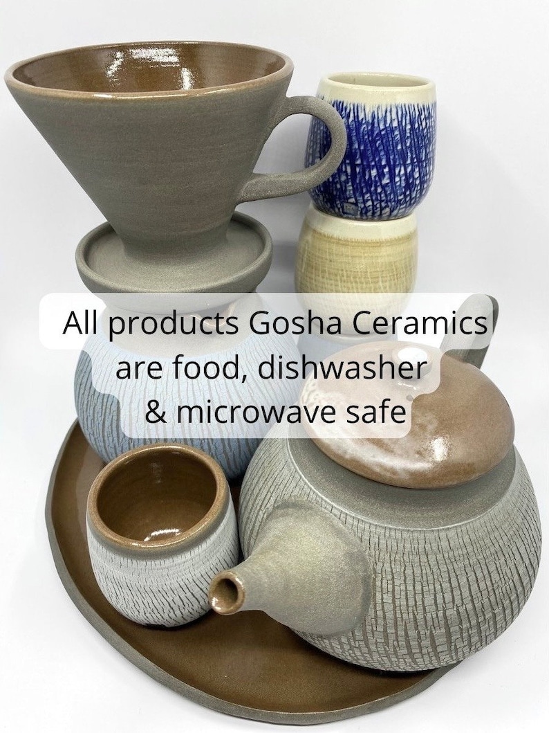 May include: A set of gray ceramic teaware, including a teapot, a teacup, a saucer, and a pour-over coffee dripper. All products Gosha Ceramics are food, dishwasher & microwave safe.