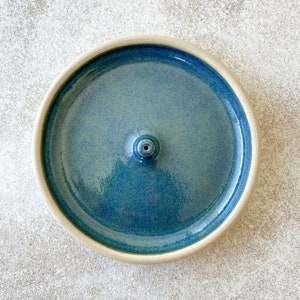 Blue handmade round ceramic incense holder.