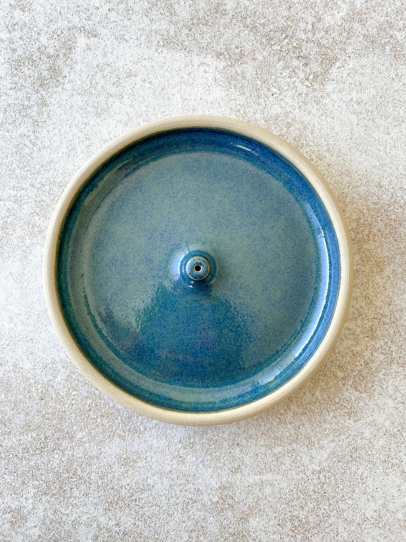 Blue handmade round ceramic incense holder.