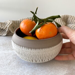 Medium handmade ceramic fruit bowl in boho style.