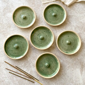 Green round pottery incense holders.