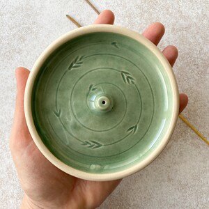 Green round ceramic incense burner.