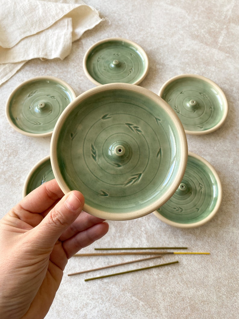 Green round pottery incense holders for cleaning your home.