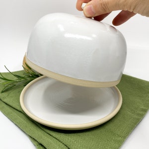 White medium-sized stoneware ceramic butter dish with lid in modern style.