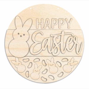May include: A round wooden sign with the words "HAPPY Easter" cut out. The sign features a large bunny and several smaller bunnies with egg shapes. The sign is made of light-colored wood and has a natural finish.