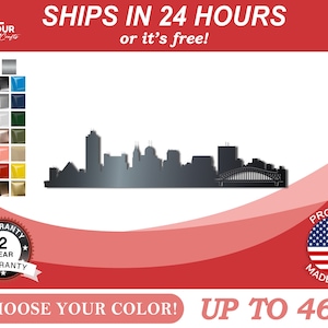 May include: Metal silhouette of a city skyline with a bridge, up to 46 inches in size. The skyline is black and the background is red. The image includes a 2-year warranty and a "Ships in 24 hours or it's free!" message.  Choose your color!  Proudly made in the USA.