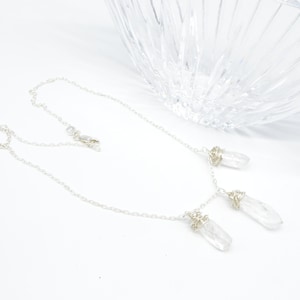 WRAP Clear, natural quartz crystal, Wrapped in a flurry of 24” of Sterling Silver wire, open loop chain and lobster claw clasp, Adjustable