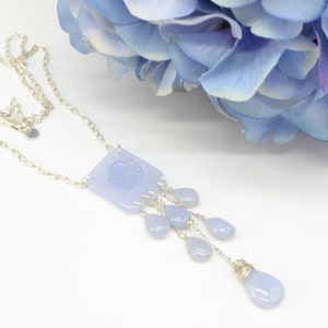 Sky blue chalcedony carved with flower with drops of three sized teardrop chalcedony one with wire wrap hung on fine silver chain. unique