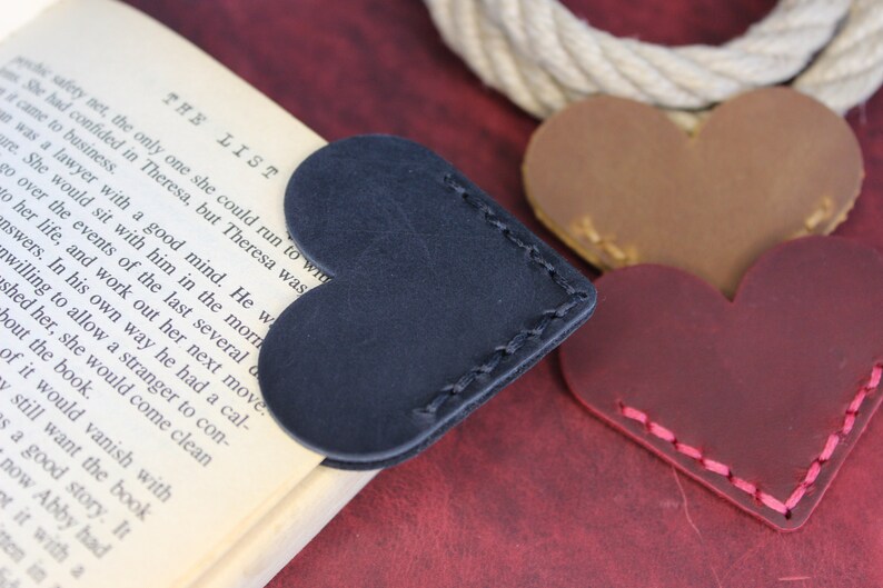 Leather heart page corner bookmark is personalized with names, dates, or initials. Offering you with many colors, these bookmarks are perfect for his tastes