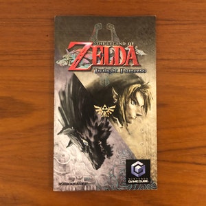May include: Instruction booklet for The Legend of Zelda: Twilight Princess for the Nintendo GameCube. The cover features the game's title in red and a character illustration. The Nintendo GameCube logo is visible.