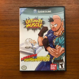 May include: Ultimate Muscle: Legends vs. New Generation video game case for Nintendo GameCube. The cover features a muscular character in a wrestling pose, with the game's title in a yellow and red burst. The game is rated Teen.