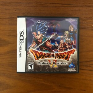 May include: A Nintendo DS game cartridge for Dragon Quest VI: Realms of Revelation. The game features a blue-haired character holding a sword and a blue slime monster on the front cover.