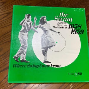 May include: A vintage vinyl record album cover with a green background. The album is titled "The Swing Era: The Music of 1938-1959." The cover features a black and white illustration of a dancing couple. The text "Where Swing Came From" is also present.
