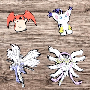 May include: Four enamel pins featuring characters from the Digimon anime series. The pins are white, red, and yellow with black outlines. The characters are a red and white digimon with wings, a white digimon with purple ears and yellow gloves, a white digimon with six arms, and a white digimon with wings and a staff.