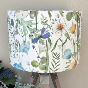 Blue and green lampshade with flowers on a table lamp
