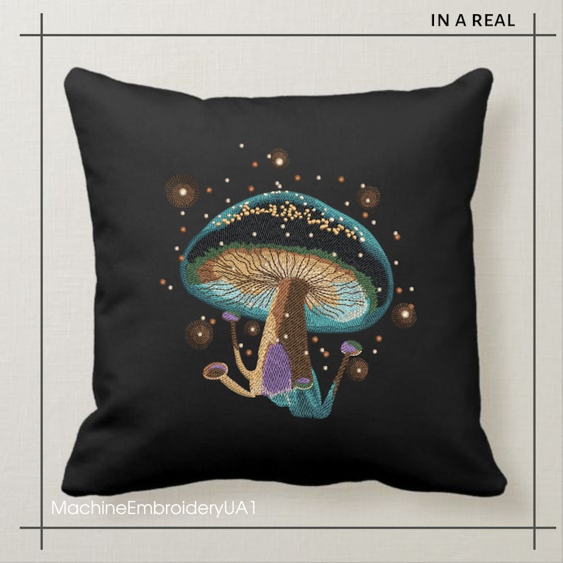 May include: A black pillow with a blue and green embroidered mushroom with a brown stem and purple accents. The mushroom is surrounded by small golden dots.