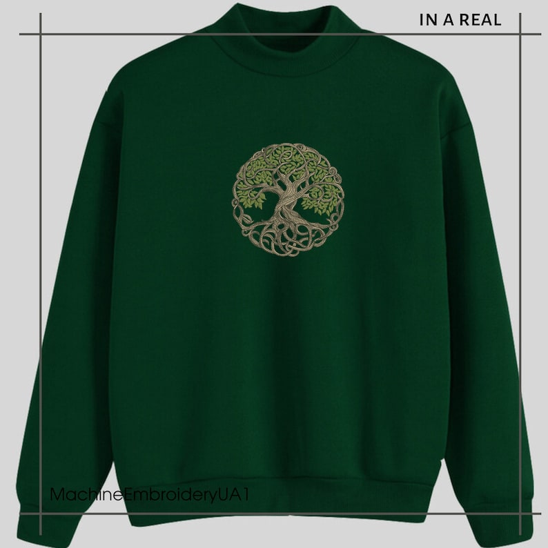 May include: A dark green sweatshirt with a circular embroidered design of a tree of life with intricate branches and roots. The text "IN A REAL" is visible in the top right corner of the image.
