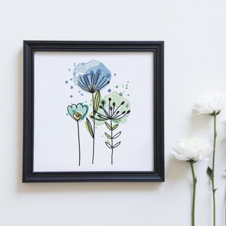 May include: A framed floral art print featuring stylized blue, green, and yellow flowers. The artwork is set against a white background and framed in a black square frame. The flowers have a watercolor effect.