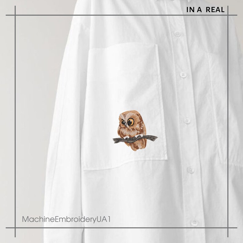 May include: White shirt with an embroidered owl design on the pocket. The owl is depicted with brown and tan feathers, sitting on a branch. The text "IN A REAL" is at the top right. The text "MachineEmbroideryUA1" is at the bottom left.