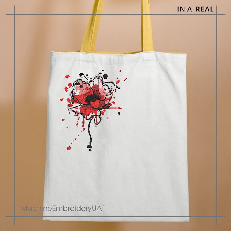 May include: White canvas tote bag with yellow handles. The bag features a red poppy flower with black outlines and red and black paint splatters.