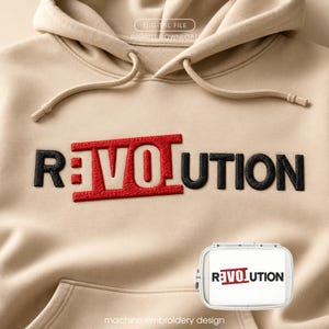 May include: A beige hoodie with the word "REVOLUTION" embroidered in black and red thread. The "RE" and "UTION" are in black, while the "VOL" is in red. A small, white rectangular design with the same text is in the lower right corner.