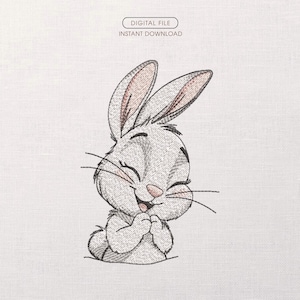 以下が含まれることがあります： 笑顔の漫画のウサギの刺繍デザイン。目は閉じられ、足は折りたたまれています。ウサギは薄いグレーで、耳の内側と鼻はピンク色です。「DIGITAL FILE INSTANT DOWNLOAD」というテキストが上部の白い楕円の中にあります。