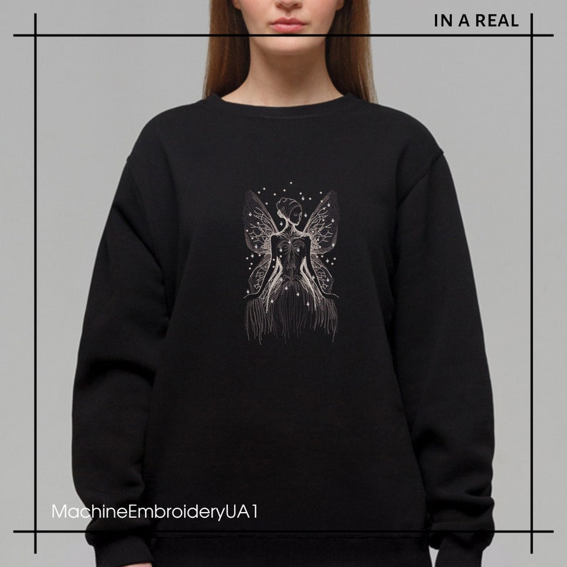 May include: Black sweatshirt with a white embroidered design of a fairy with wings and stars. The text "MachineEmbroideryUA1" is at the bottom of the image.
