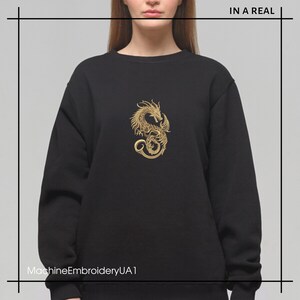 May include: Black sweatshirt with a gold embroidered dragon design. The text "MachineEmbroideryUA1" is at the bottom of the image.