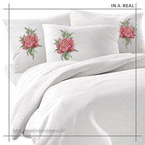 May include: Three white pillowcases with embroidered pink peonies on each. The pillowcases are on a white bedspread. The text "IN A REAL" is in the upper right corner of the image. The text "MachineEmbroideryUA1" is in the lower left corner of the image.