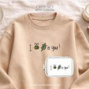 May include: A beige sweatshirt with the phrase "I bee in you!" embroidered in black, yellow, and green. The design includes a bee and a leaf. A smaller version of the design is on a white embroidery hoop. The words "DIGITAL FILE" and "INSTANT DOWNLOAD" are at the top.