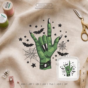 May include: An embroidery design featuring a green hand making a rock-and-roll gesture, adorned with black bracelets and long nails. The design includes black spiderwebs, bats, and stars. Text reads DIGITAL FILE INSTANT DOWNLOAD and file formats.