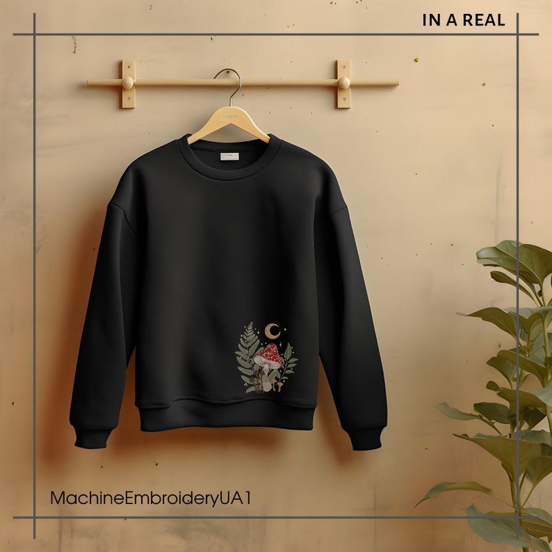 May include: Black sweatshirt with a mushroom and moon graphic embroidered on the left chest. The text "MachineEmbroideryUA1" is printed below the image.